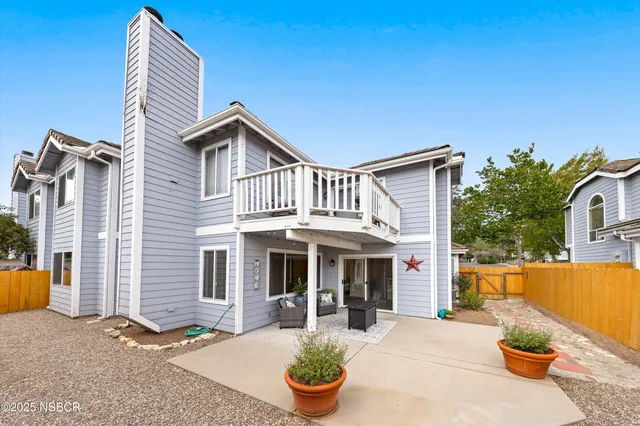 a front view of house with yard outdoor seating and barbeque oven