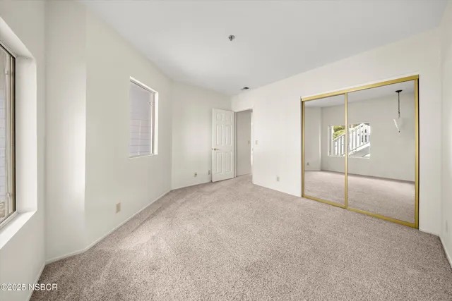 a view of a kitchen with a sink and a mirror