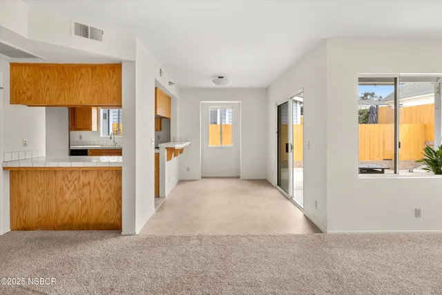 a view of a kitchen with wooden floor and a kitchen