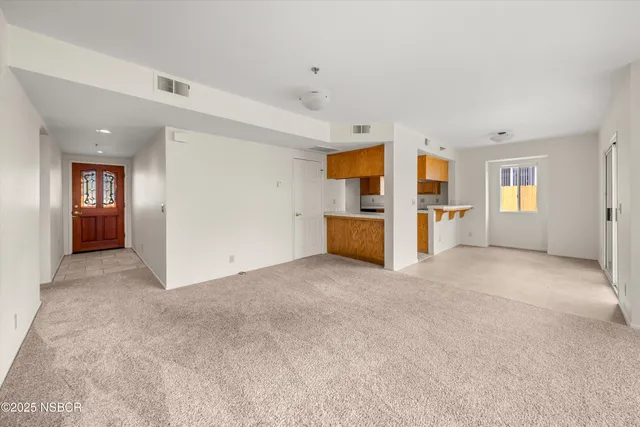 an empty room with a window and fireplace