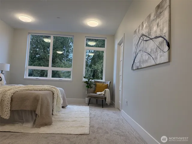 a bedroom with a bed and glass window