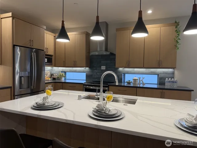 a kitchen with a sink and refrigerator