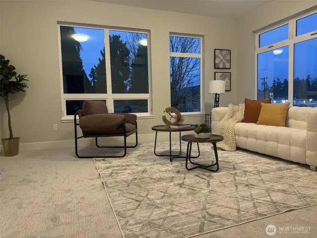 a living room with furniture and a potted plant