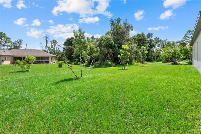 a view of grassy field with benches