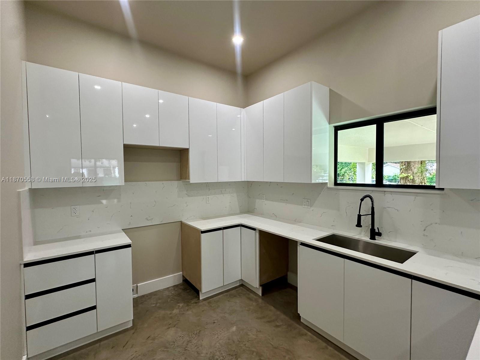 929 Northwest 60th Street Miami, FL 33127 - Photo 13 of 58 a kitchen with a sink cabinets and window