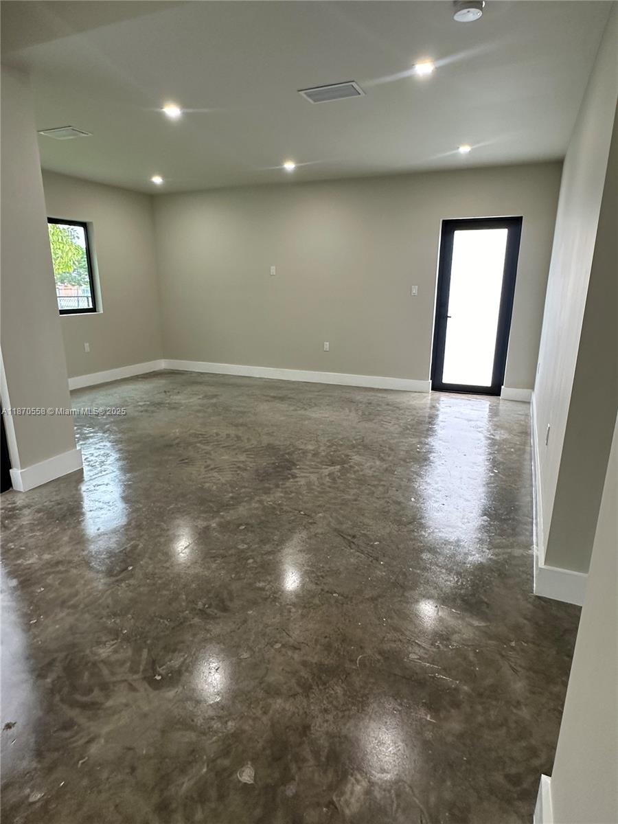 929 Northwest 60th Street Miami, FL 33127 - Photo 21 of 58 an empty room with windows and entrance