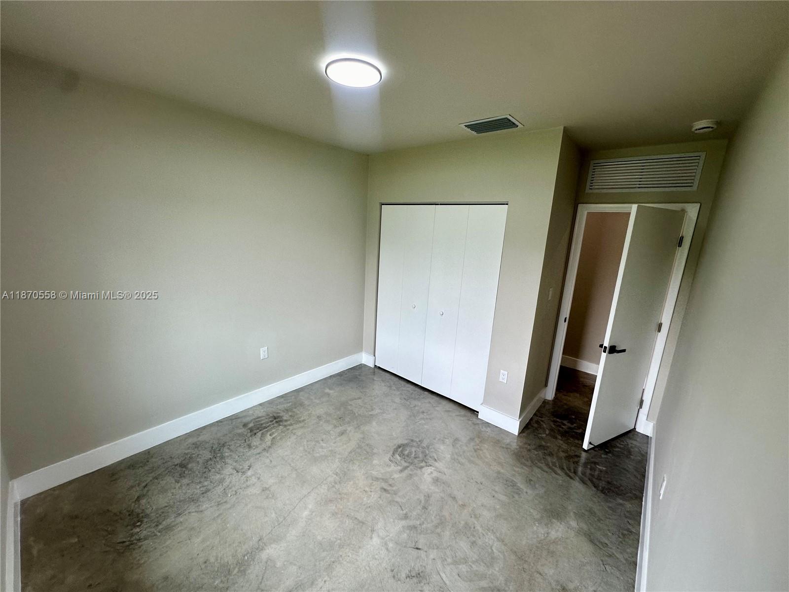 929 Northwest 60th Street Miami, FL 33127 - Photo 23 of 58 an empty room with a mirror