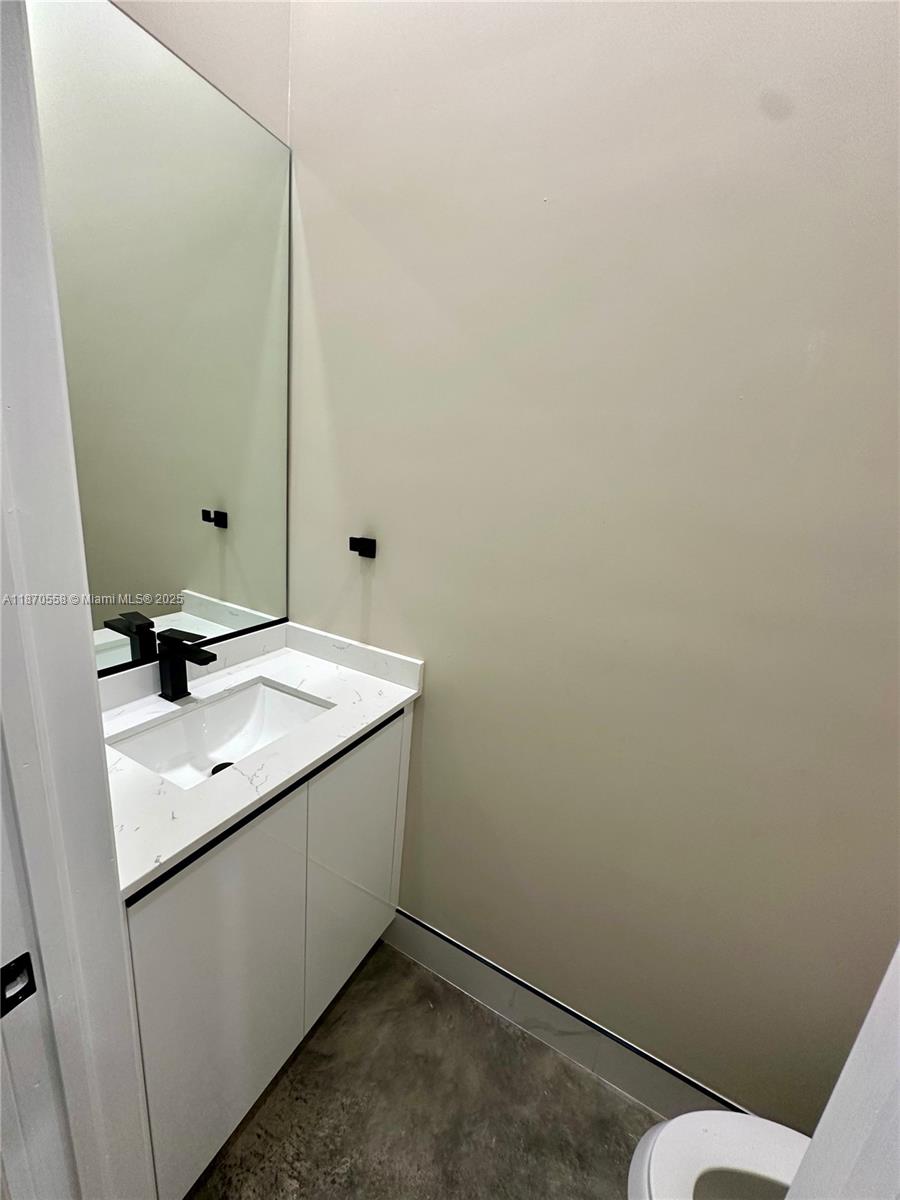 929 Northwest 60th Street Miami, FL 33127 - Photo 25 of 58 a bathroom with a sink toilet and mirror