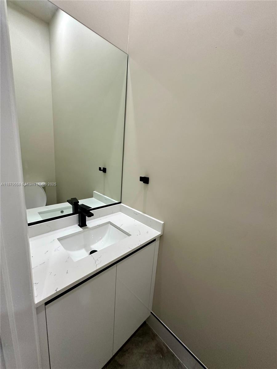 929 Northwest 60th Street Miami, FL 33127 - Photo 26 of 58 a bathroom with a sink and a mirror