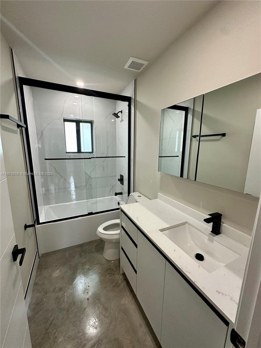 929 Northwest 60th Street Miami, FL 33127 - Photo 29 of 58 a bathroom with a sink mirror and tub