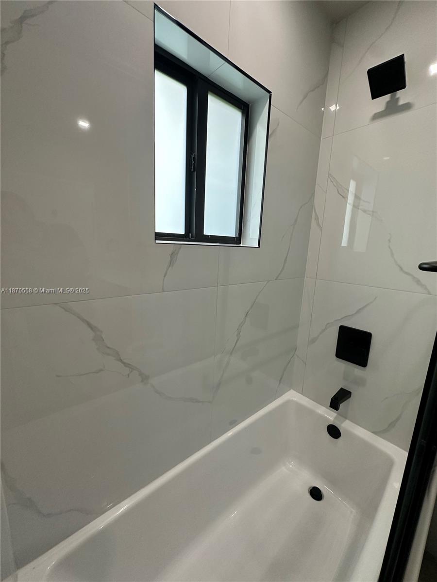 929 Northwest 60th Street Miami, FL 33127 - Photo 31 of 58 a bathroom with a bathtub