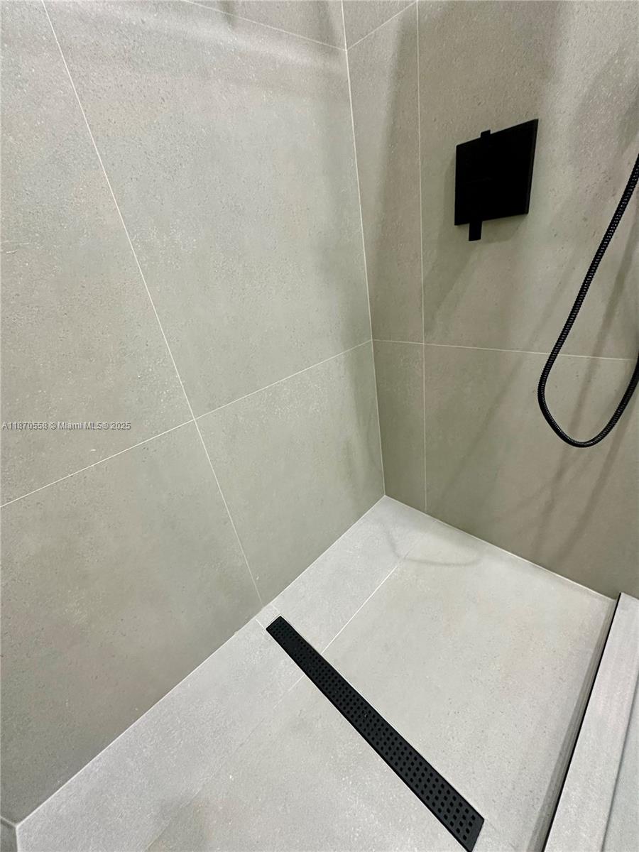 929 Northwest 60th Street Miami, FL 33127 - Photo 37 of 58 a bathroom with a shower and a sink