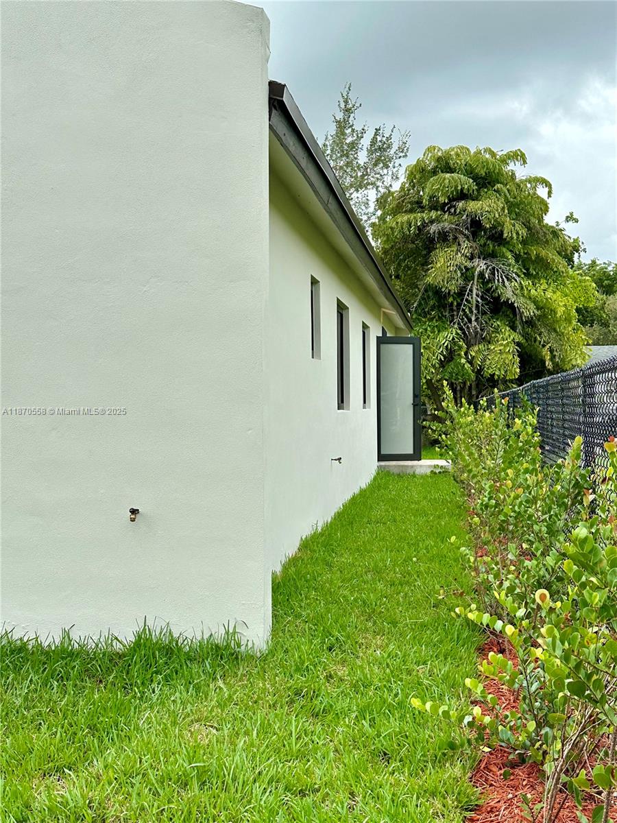 929 Northwest 60th Street Miami, FL 33127 - Photo 40 of 58 a house with a small yard