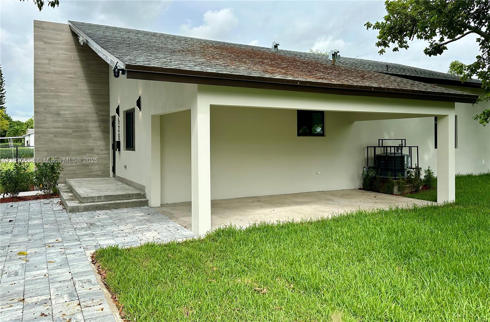 929 Northwest 60th Street Miami, FL 33127 - Photo 47 of 58 a front view of a house with a yard