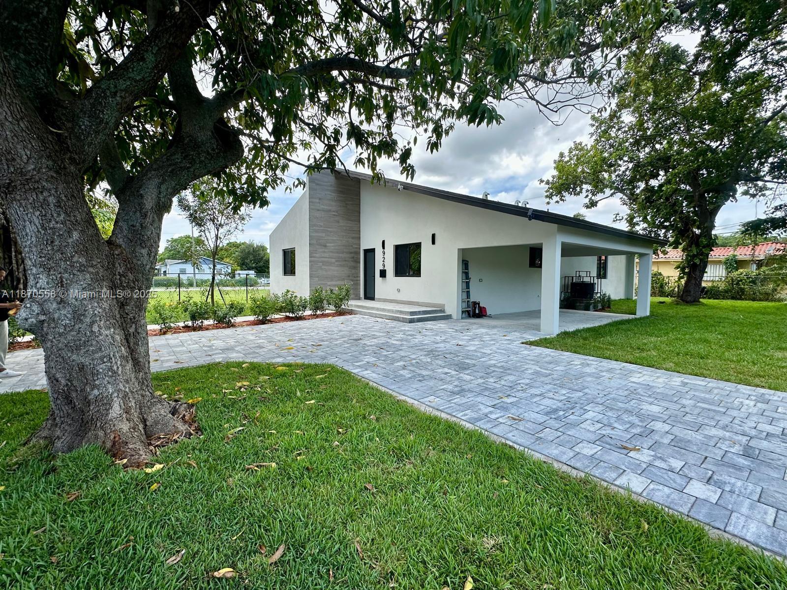 929 Northwest 60th Street Miami, FL 33127 - Photo 5 of 58 a front view of house with yard and green space