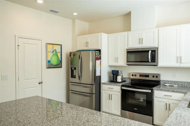 a bedroom with two beds and a chandelier