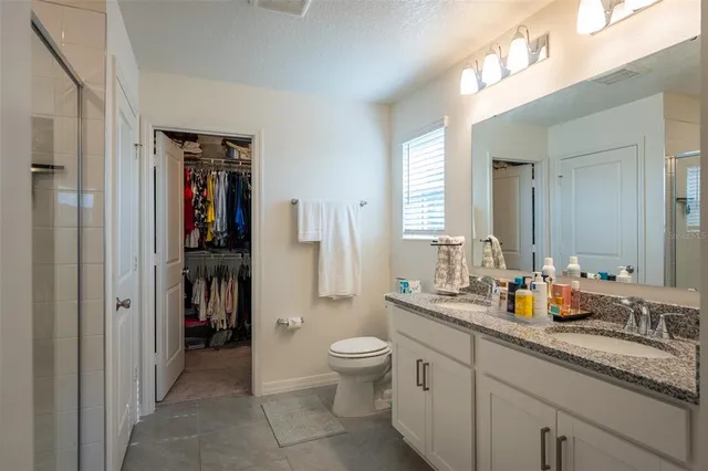 a bathroom with a shower and a sink
