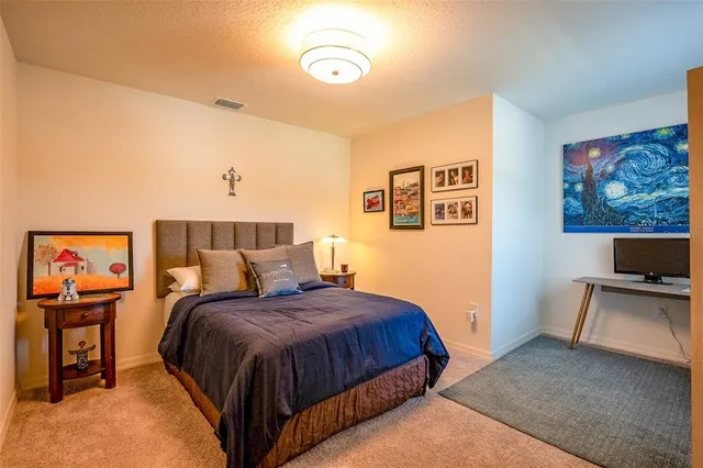 a bedroom with a bed and a book shelf