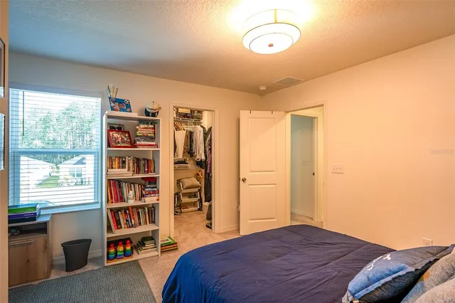a bathroom with a granite countertop sink toilet and a mirror