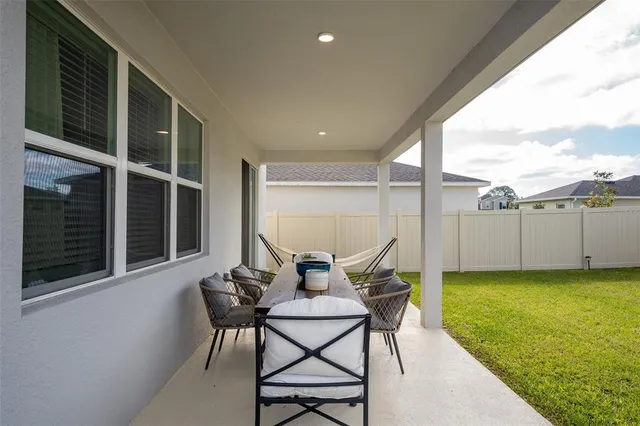 a view of a house with a backyard and porch
