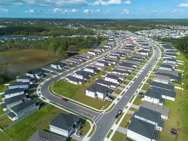 an aerial view of a house with pool yard and outdoor seating
