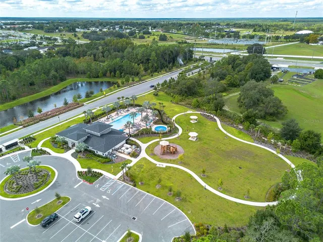 a view of a swimming pool with a garden and trees