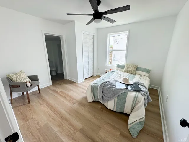 a bedroom with a bed and wooden floor