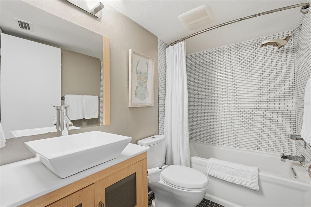6415 Midnight Pass Road, Unit 211 Sarasota, FL 34242 - Photo 34 of 58 a bathroom with a sink toilet vanity and shower