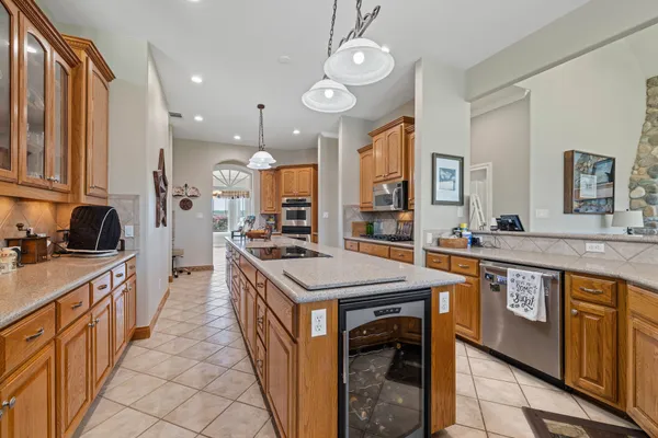 a kitchen with stainless steel appliances granite countertop sink stove and refrigerator