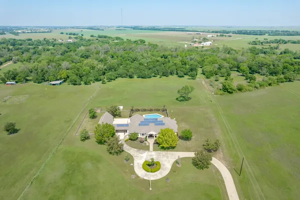 an aerial view of a houses with outdoor space and a lake view