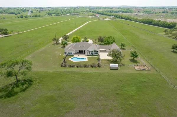 an aerial view of a house with a swimming pool