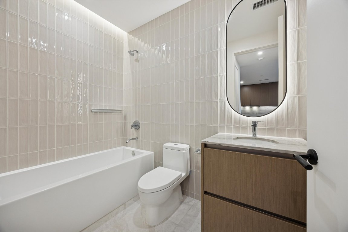 610 Davis Street, Unit 3204 Austin, TX 78701 - Photo 11 of 27 a bathroom with a sink toilet and shower