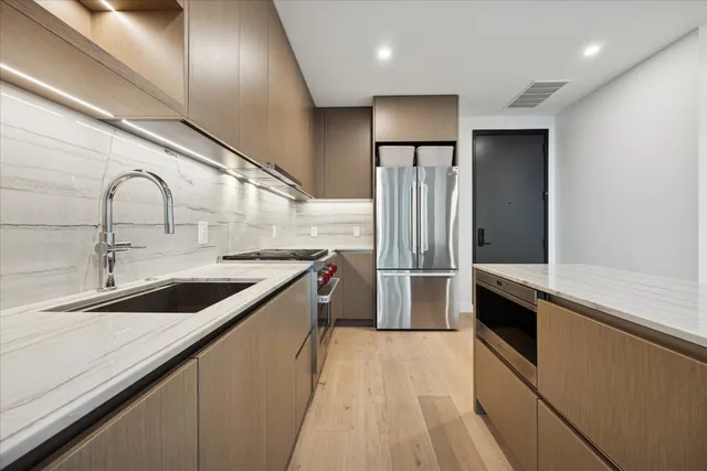 a kitchen with stainless steel appliances a sink and cabinets