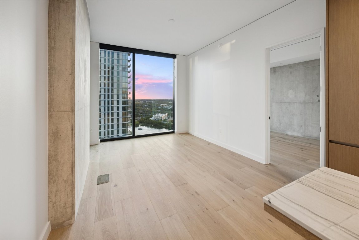 610 Davis Street, Unit 3204 Austin, TX 78701 - Photo 5 of 27 a view of an empty room with wooden floor and a window