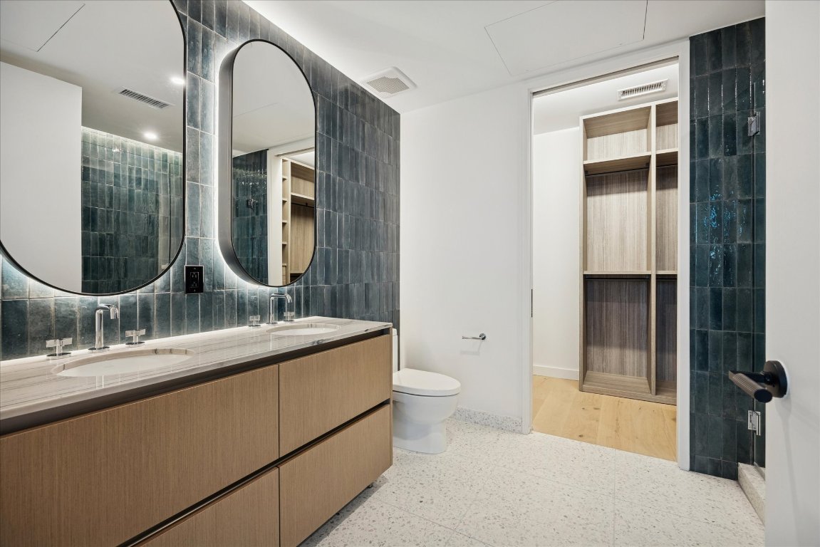 610 Davis Street, Unit 3204 Austin, TX 78701 - Photo 10 of 27 a en suite bathroom with a granite countertop sink and a mirror