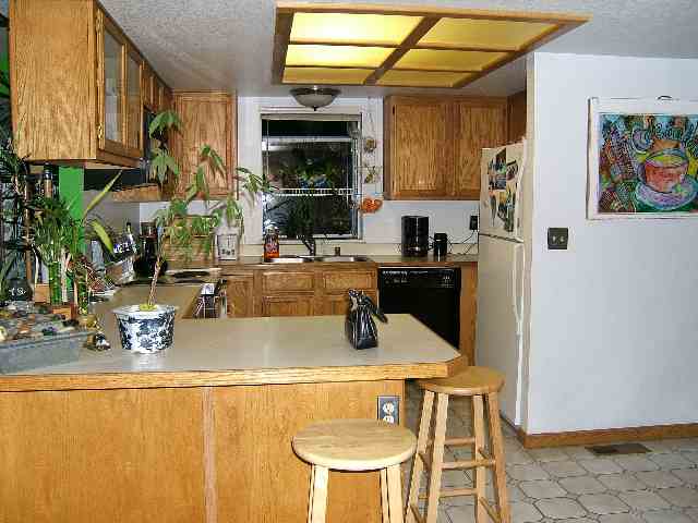 2181 Cobblestone Court Reno, NV 89503 - Photo 7 of 8 a kitchen with a sink a stove and a refrigerator