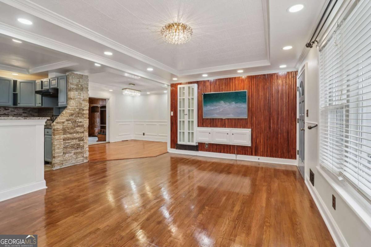 716 Carolina Roads Marietta, GA 30008 - Photo 12 of 54 a view of an empty room with wooden floor and a window