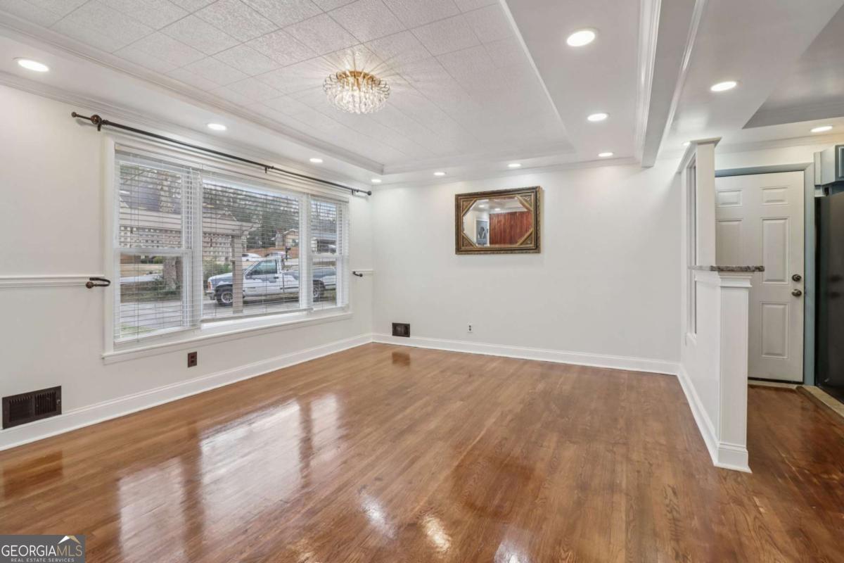 716 Carolina Roads Marietta, GA 30008 - Photo 14 of 54 a view of empty room with wooden floor and fan
