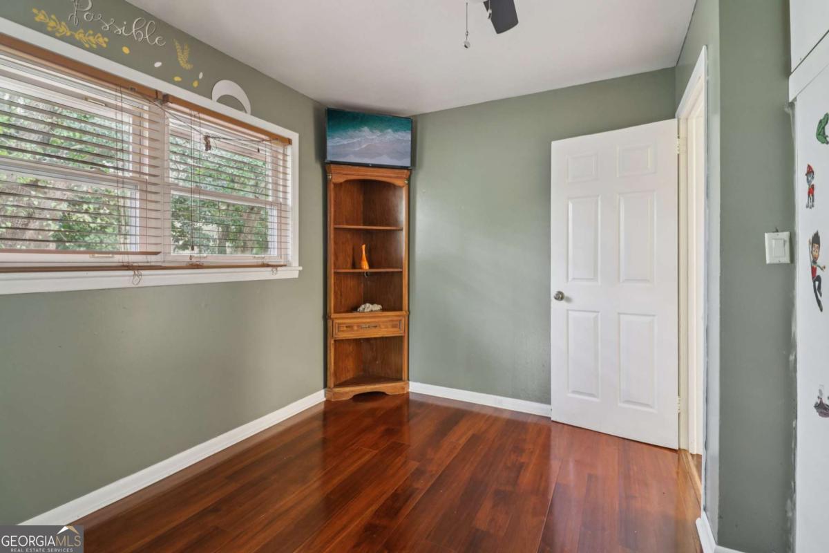 716 Carolina Roads Marietta, GA 30008 - Photo 23 of 54 a view of an empty room with wooden floor and a window