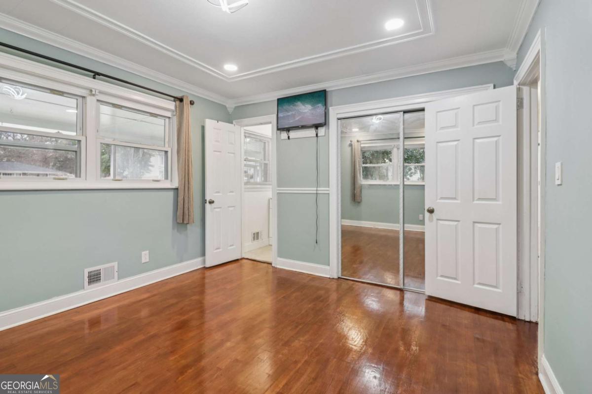 716 Carolina Roads Marietta, GA 30008 - Photo 28 of 54 an empty room with wooden floor and windows