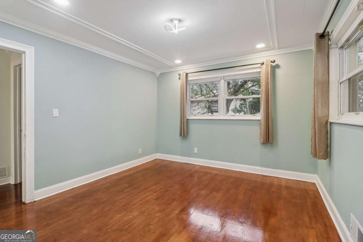 716 Carolina Roads Marietta, GA 30008 - Photo 30 of 54 an empty room with wooden floor and windows