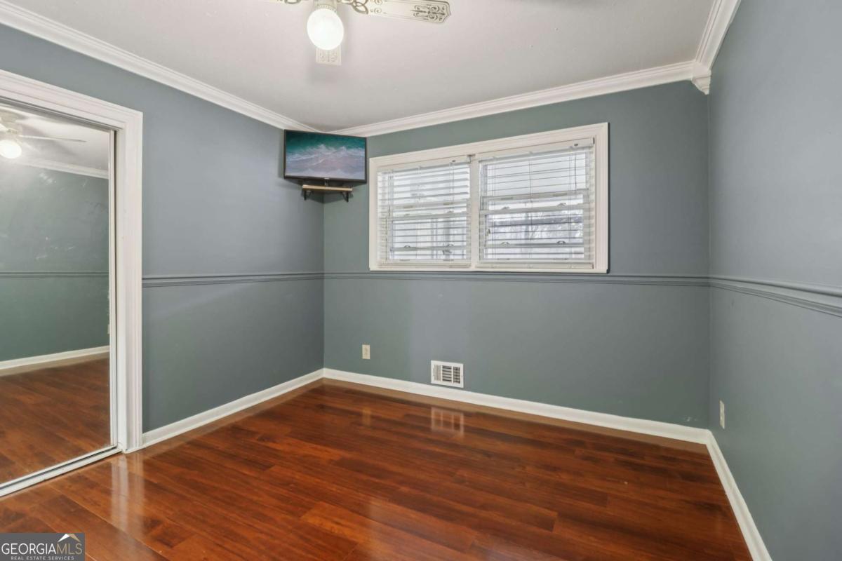 716 Carolina Roads Marietta, GA 30008 - Photo 32 of 54 an empty room with wooden floor and windows