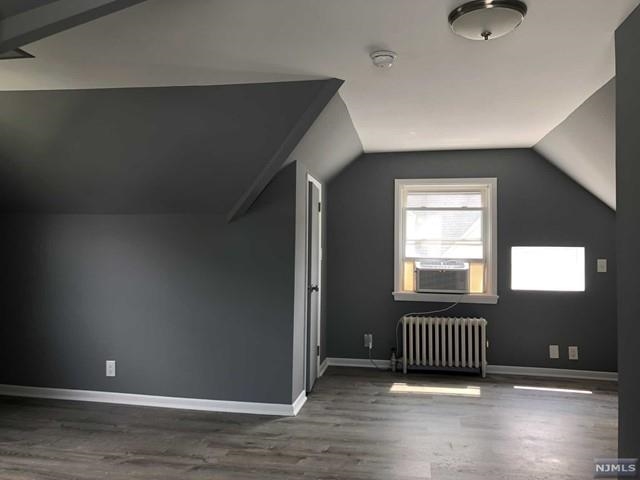 166 Carmita Avenue, Unit 2 Rutherford, NJ 07070 - Photo 20 of 27 an empty room with wooden floor and windows