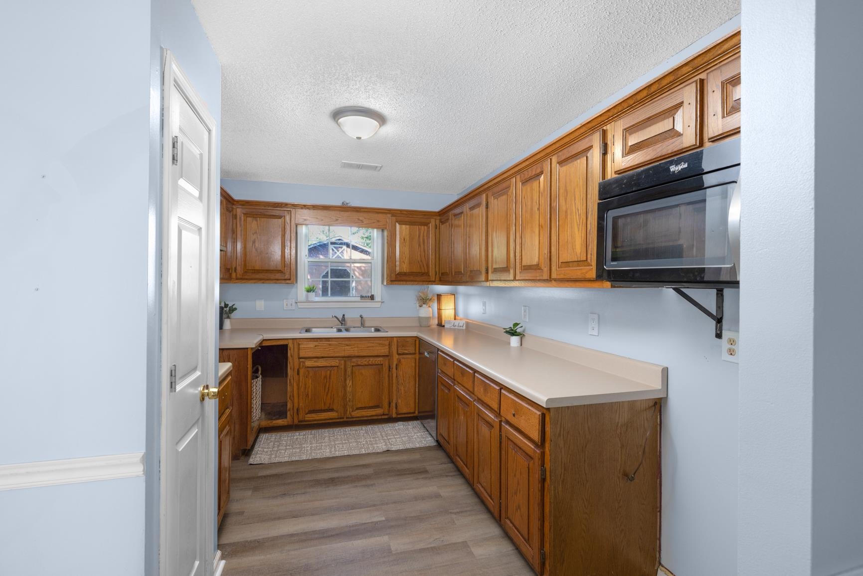 366 Adkins Road Burlison, TN 38015 - Photo 7 of 20 Kitchen featuring wood-finish cabinetry, light-toned countertops, and a built-in microwave