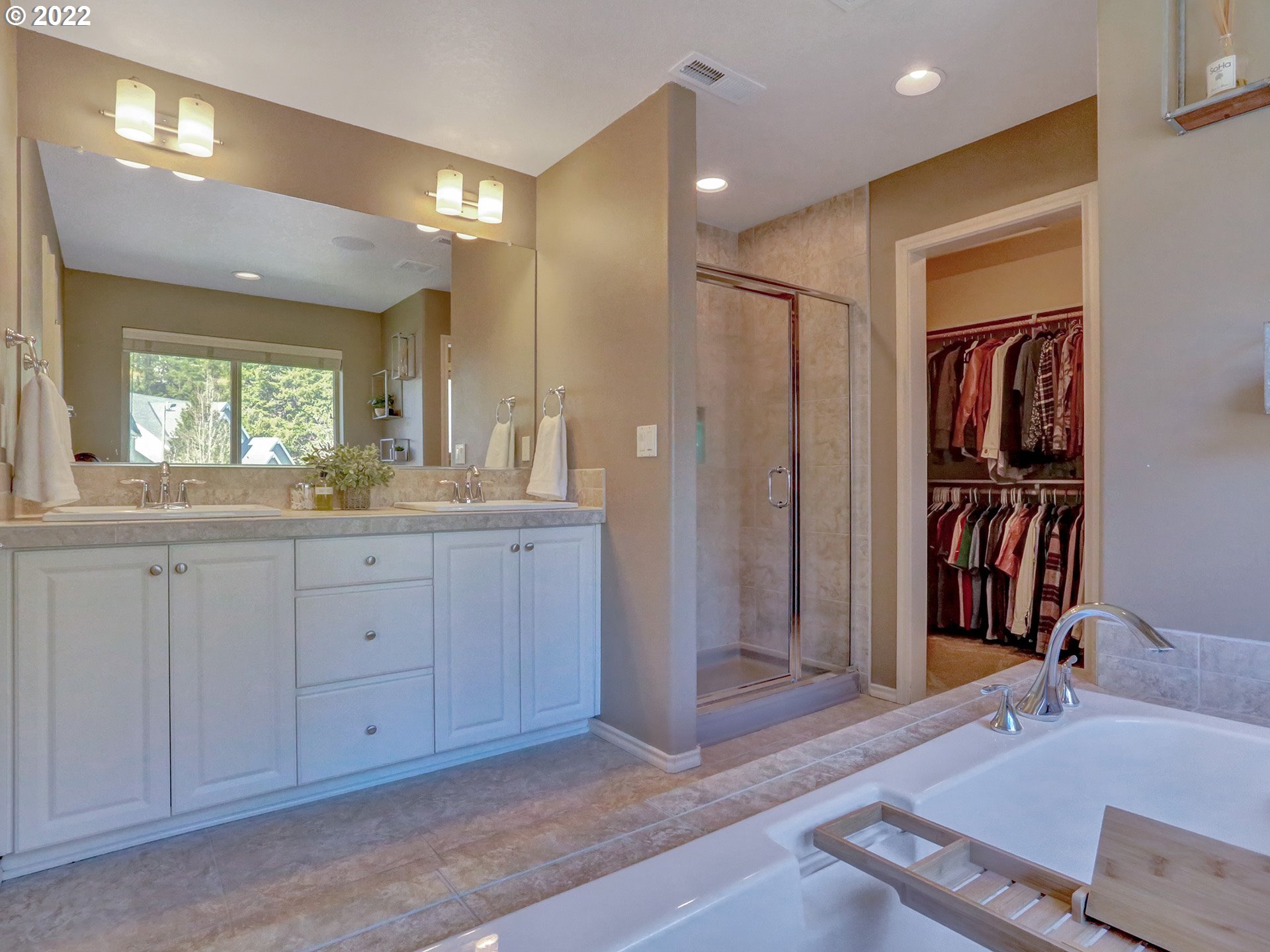 1098 Epperly Way West Linn, OR 97068 - Photo 20 of 32 a spacious bathroom with a granite countertop sink and a mirror
