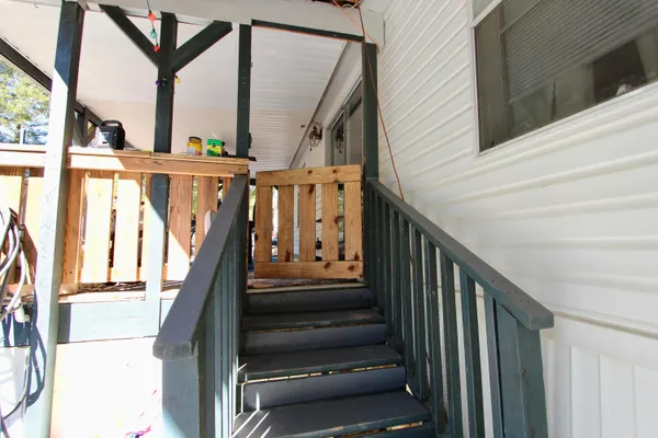 a view of a chair and table in the balcony
