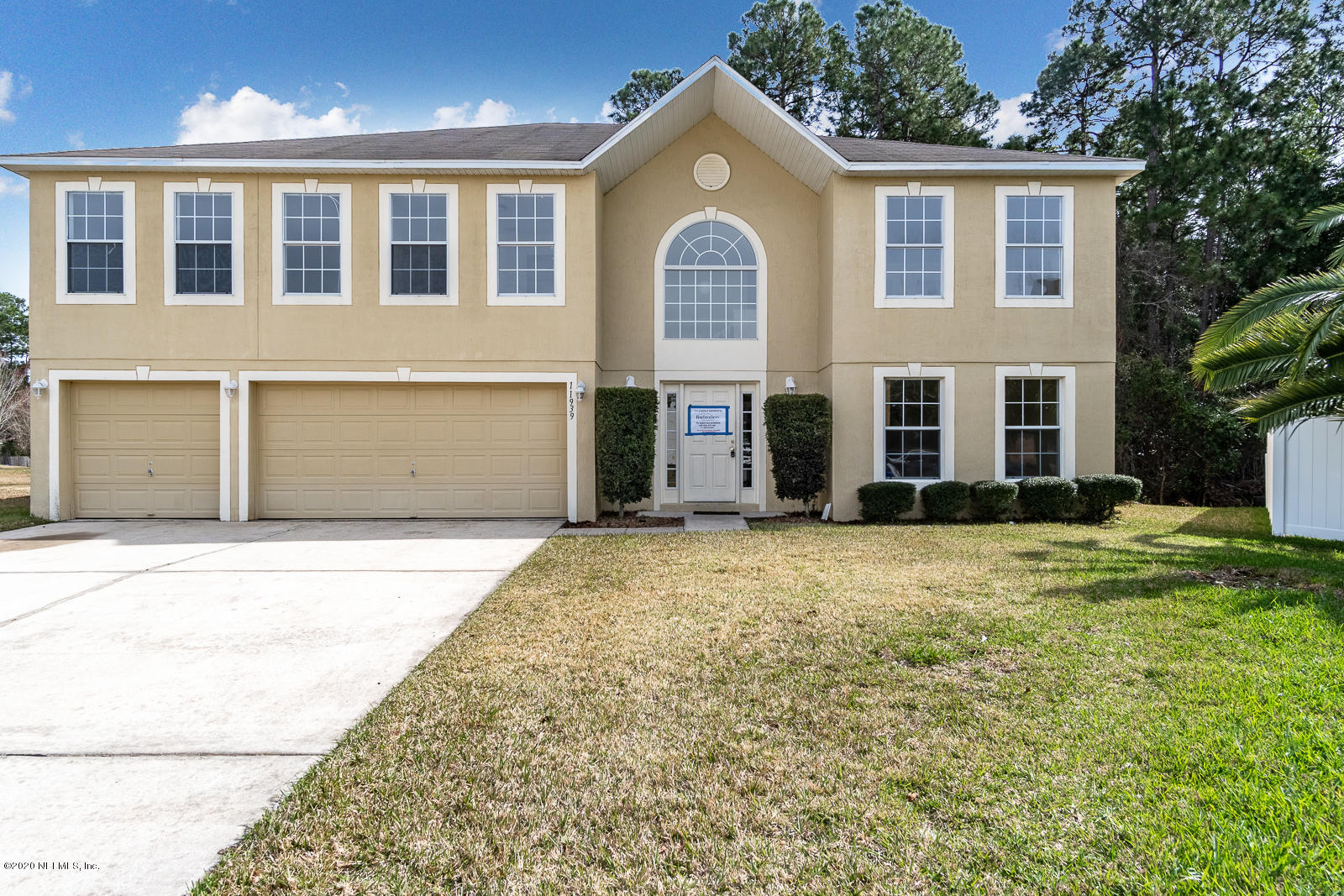 11939 Iron Creek Road Jacksonville, FL 32218 - Photo 1 of 45 front view of a house with a yard