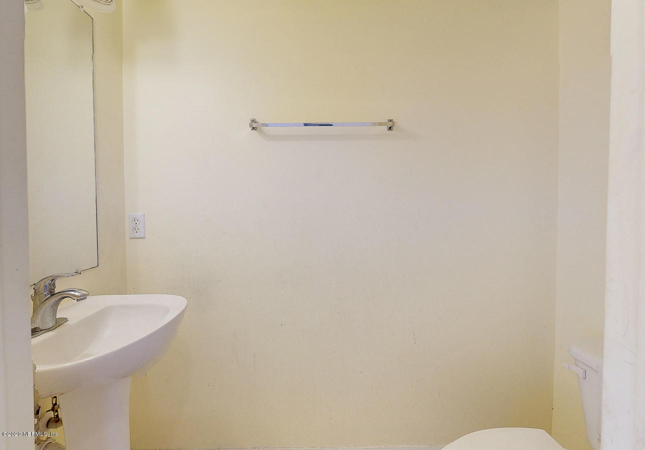 11939 Iron Creek Road Jacksonville, FL 32218 - Photo 11 of 45 a bathroom with a sink and a toilet