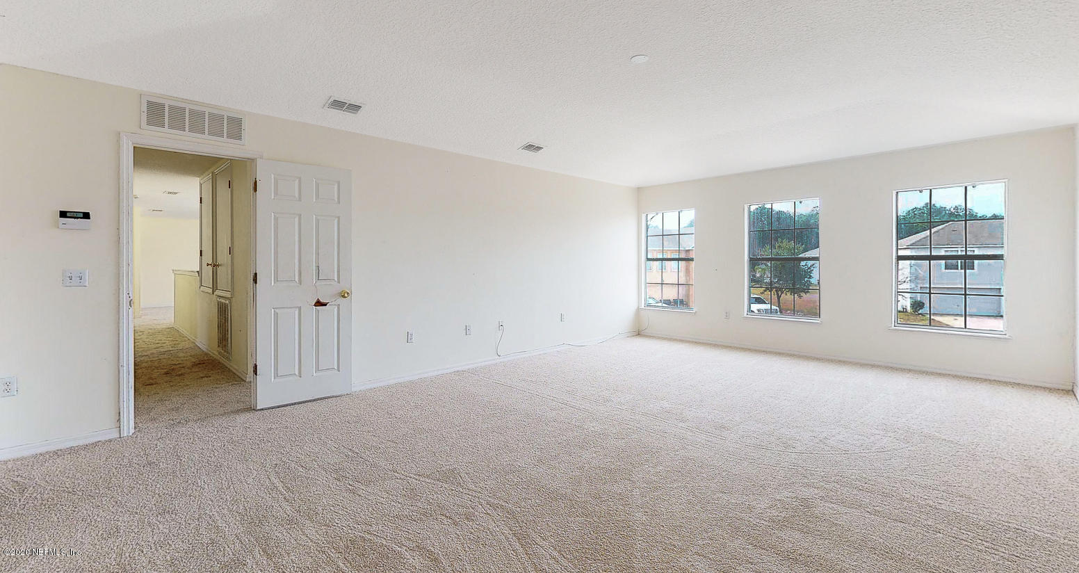 11939 Iron Creek Road Jacksonville, FL 32218 - Photo 15 of 45 a view of a big room with windows and chandelier fan