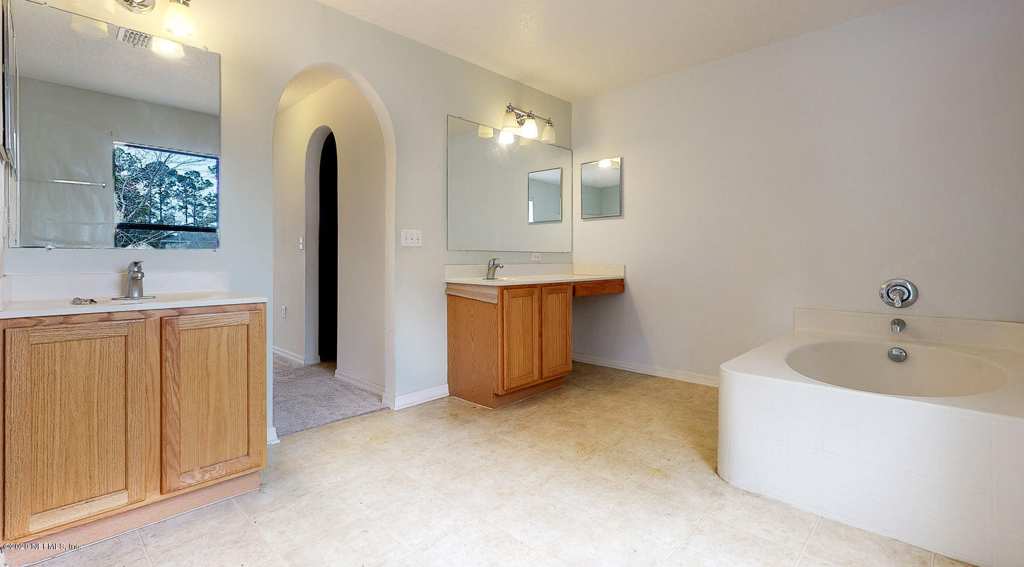 11939 Iron Creek Road Jacksonville, FL 32218 - Photo 18 of 45 a bathroom with a bathtub sink and mirror